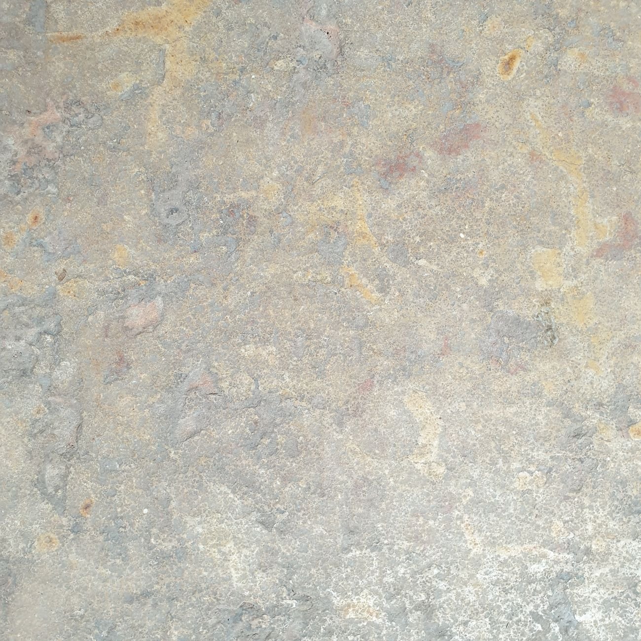 Detailed close-up of natural stone surface showing intricate texture and tone variation